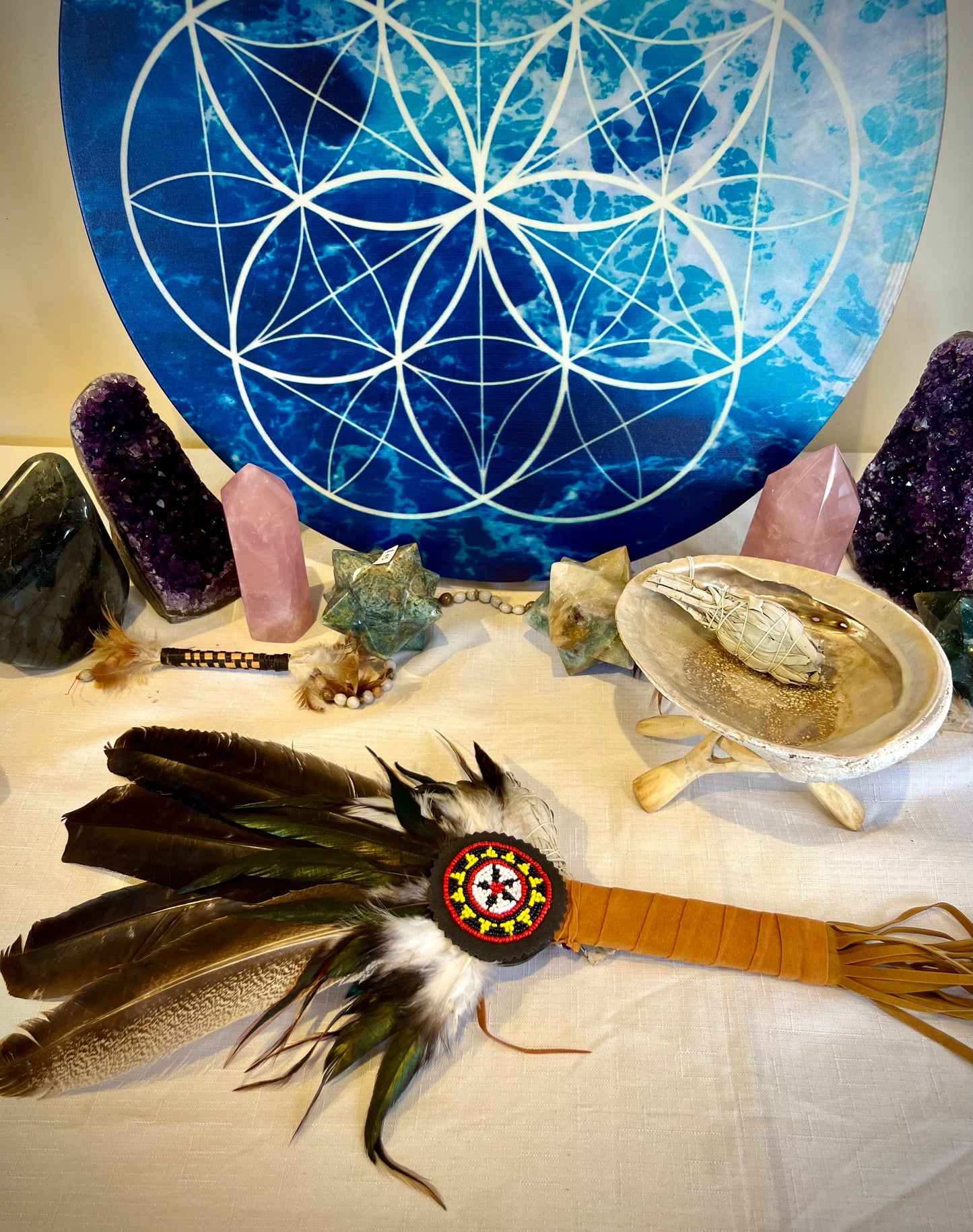 Handcrafted cleansing wand with four dark feathers